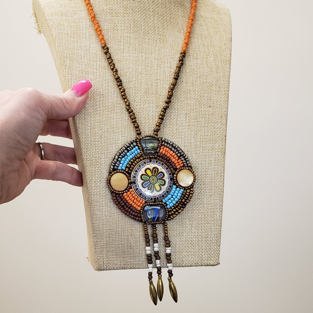Brown, blue orange beaded, glass, stone, enamel medallion tassel bead necklace